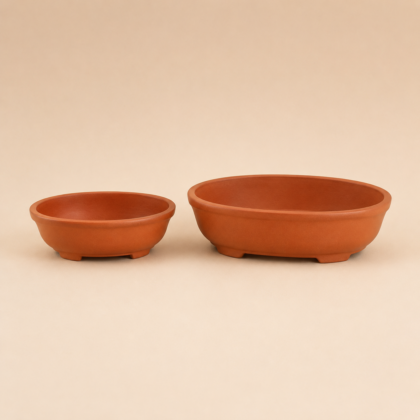 Two terracotta oval bonsai planters in different sizes on a neutral background.