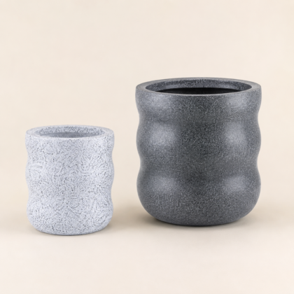 Two curved planters in different sizes and speckled finishes against a neutral background.