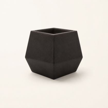 Dark geometric faceted Diamond Planter on a light background.