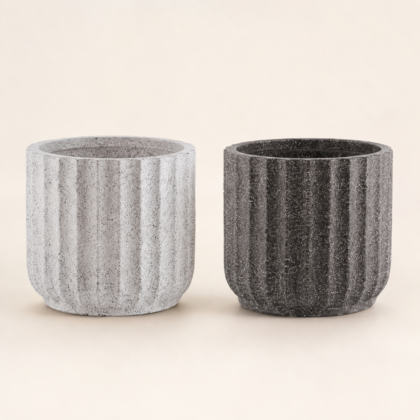 Two vertical-ribbed Paris Planters in light grey and dark charcoal finishes against a neutral background.