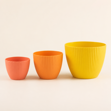 Three ribbed Rainbow Planters in peach, orange, and yellow displayed in increasing sizes.