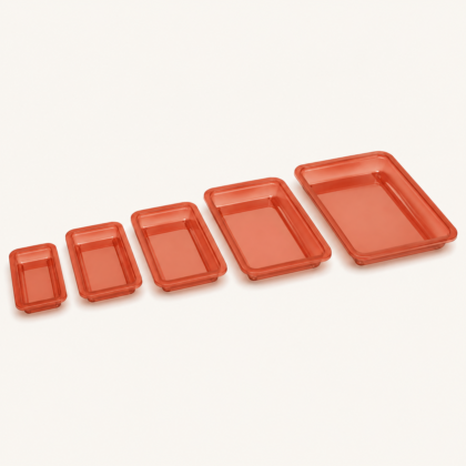 Five rectangular planter plates in graduated sizes, lined up diagonally on a light background.