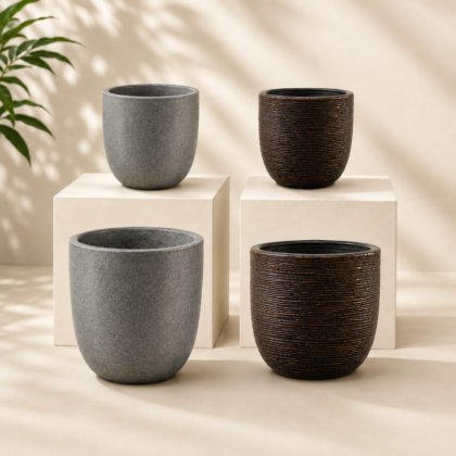 Four Ribu Planters in grey and ribbed dark brown displayed on and around light pedestals.