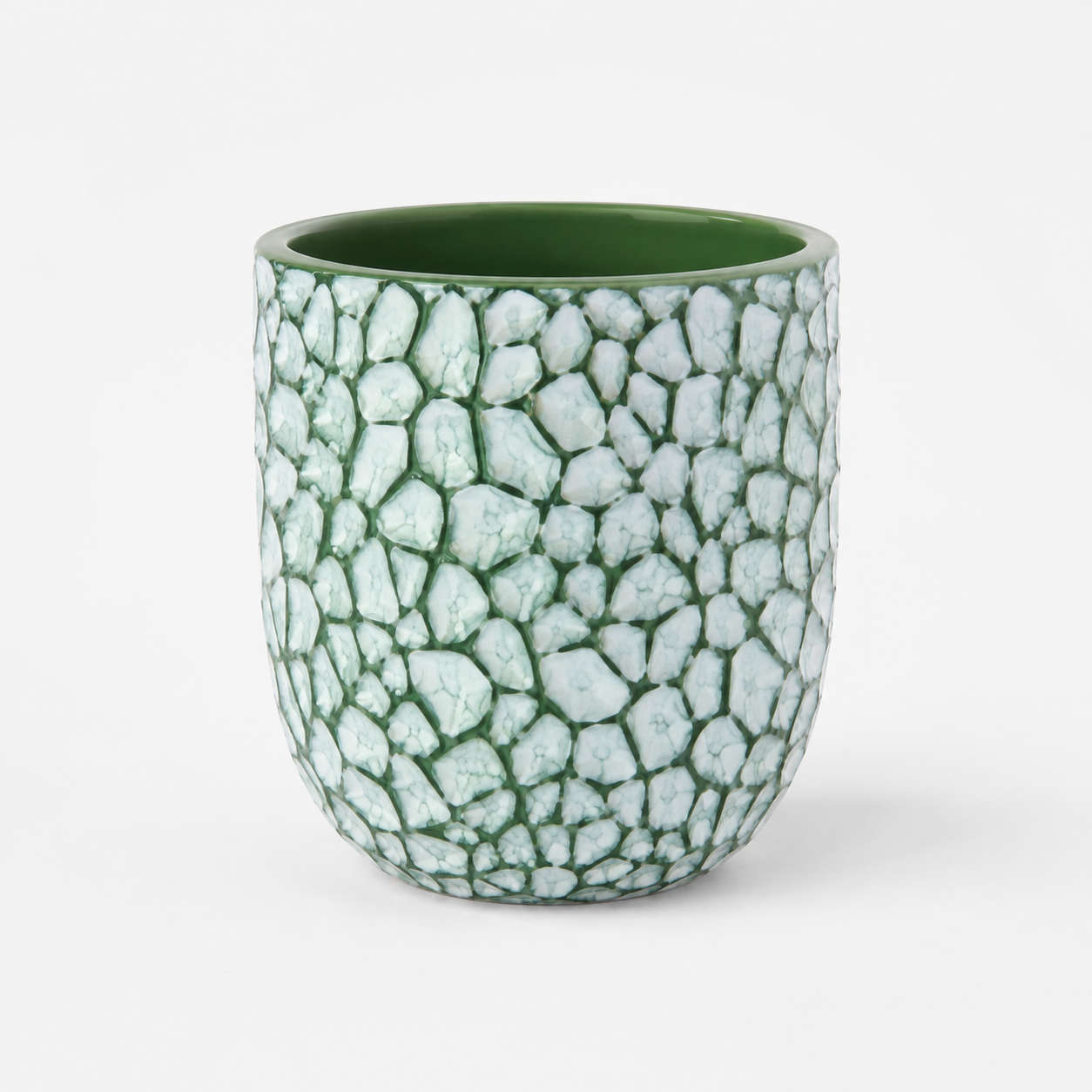 Green rock planter with a textured pebble pattern exterior.