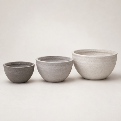 Three Roto Lotus Planters in graduating sizes and shades against a neutral background.