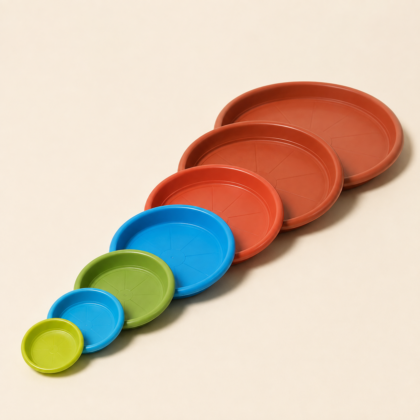 A diagonal line of seven round planter plates in ascending order of size and various colors.