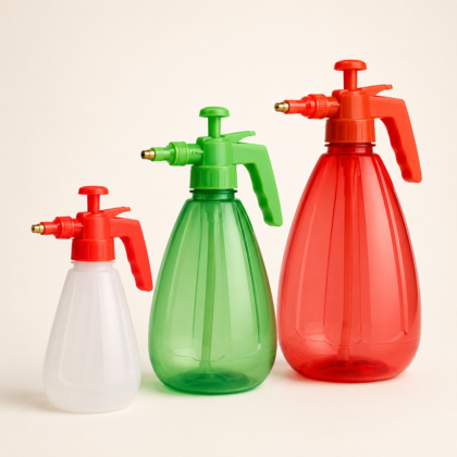 Three spray pumps in different sizes and translucent colors arranged side by side.