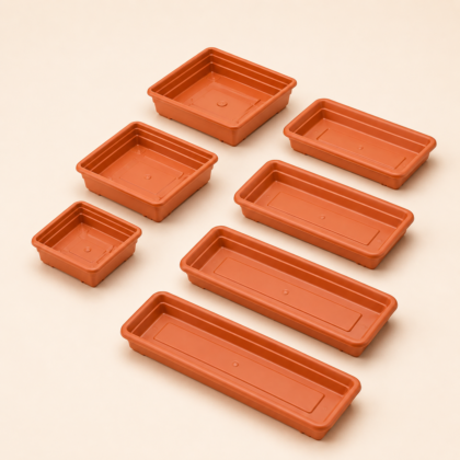 Various sizes of square and rectangular terracotta-colored planter plates arranged on a neutral surface.