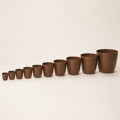 Ten Stella Colour Planters in graduating sizes arranged in a line from smallest to largest on a neutral background.