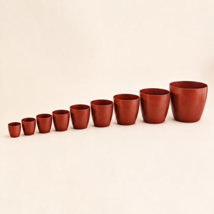 Lineup of Stella Fancy Planters in graduated sizes from small to large.