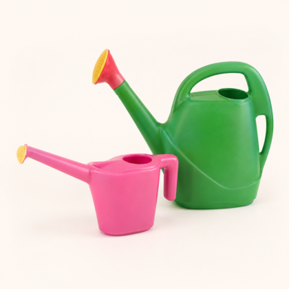 Two plastic watering cans in green and pink against a light background.