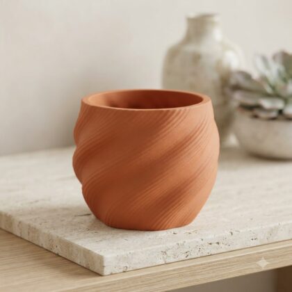 Imperia decorative pot with a textured, spiral design on a surface.