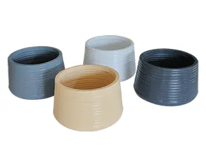 Four ribbed planters in blue, beige, white, and dark grey arranged on a white background.